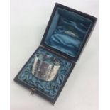 A boxed Edwardian silver napkin ring decorated with flowe