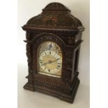 A good quality oak carved bracket clock with gilde