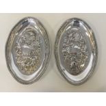 A good pair of oval silver embossed sweet dishes w