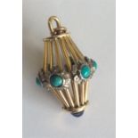 A heavy turquoise and diamond pendant with cabocho