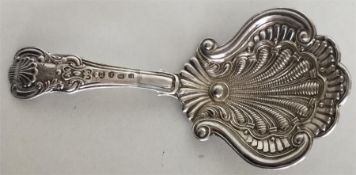 A fancy scroll decorated silver caddy spoon with s