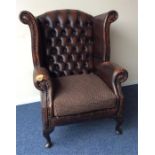 A leather button-back smokers' chair on cabriole l