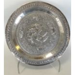A heavy Indian silver dish profusely decorated wit
