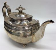 A Georgian silver boat-shaped teapot with hinged top on b