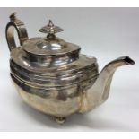 A Georgian silver boat-shaped teapot with hinged top on b