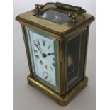 A brass striking carriage clock on bracket feet. E