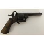 An Antique pin capped revolver with mahogany handl