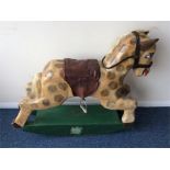 An unusual painted wooden rocking horse with leath