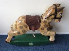 An unusual painted wooden rocking horse with leath