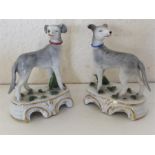 A pair of miniature Staffordshire dogs decorated w