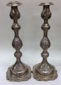 A tall pair of Edwardian silver candlesticks decor