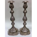 A tall pair of Edwardian silver candlesticks decor