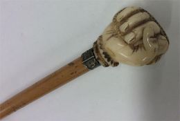A tapering walking cane with ivory mount carved in