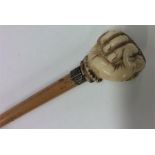 A tapering walking cane with ivory mount carved in