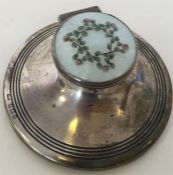 A circular silver and enamelled capstan inkwell wi