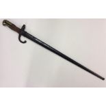 An Antique brass and mahogany-mounted bayonet. Est