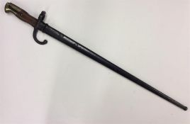 An Antique brass and mahogany-mounted bayonet. Est