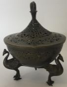 A brass pot pourri on peacock base with lift-off c