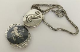 An oval silver locket on chain together with an Ea