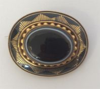 A high carat gold oval agate and enamelled target