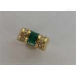 A heavy 18 carat emerald cocktail ring inset with