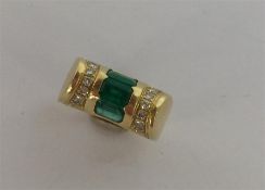 A heavy 18 carat emerald cocktail ring inset with