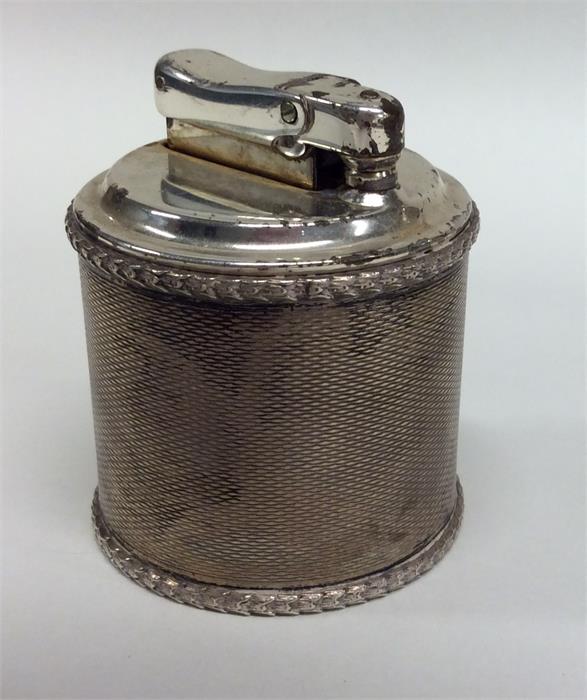 An unusual silver engine turned table lighter. Lon