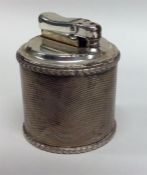 An unusual silver engine turned table lighter. Lon