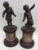 A pair of Edwardian brass figures of children on m