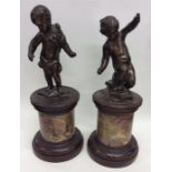 A pair of Edwardian brass figures of children on m