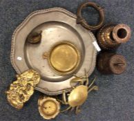 A collection of brass paperweights, stands, bell e