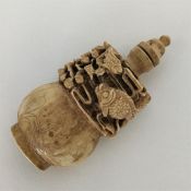 An unusual carved ivory scent bottle decorated wit
