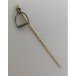 A high carat gold stick pin in the form of a stirr