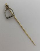 A high carat gold stick pin in the form of a stirr
