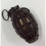 A deactivated hand grenade. Est. £30 - £40.