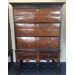 A mahogany veneered three drawer chest on stand wi