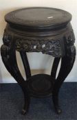 A circular Chinese pedestal jardiniere stand on ta
