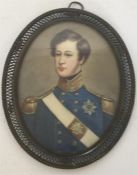 An oval miniature of a soldier in blue jacket, wit