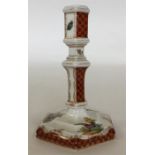 A Berlin octagonal porcelain candlestick painted w