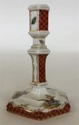 A Berlin octagonal porcelain candlestick painted w