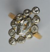 An attractive marquise cluster ring, the large cen
