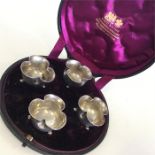 A boxed set of four Victorian silver salts on ball
