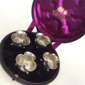 A boxed set of four Victorian silver salts on ball