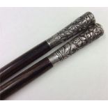 Two Chinese silver topped canes. Est. £50 - £80.