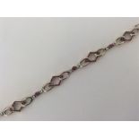 A stylish gold and platinum bracelet with ruby and