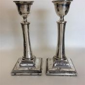 A pair of tapering silver candlesticks with ball d