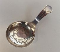 A Georgian silver bright cut caddy spoon with cent