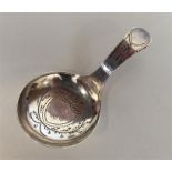 A Georgian silver bright cut caddy spoon with cent