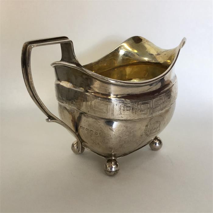 A good Georgian silver bright cut cream jug on bal - Image 3 of 3
