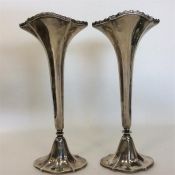 A tall pair of tapering silver spill vases with ga